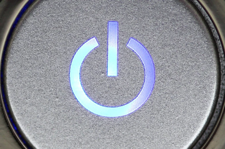 a close up of a button with a blue light, flickr, power stance, top down view, symbol, gray