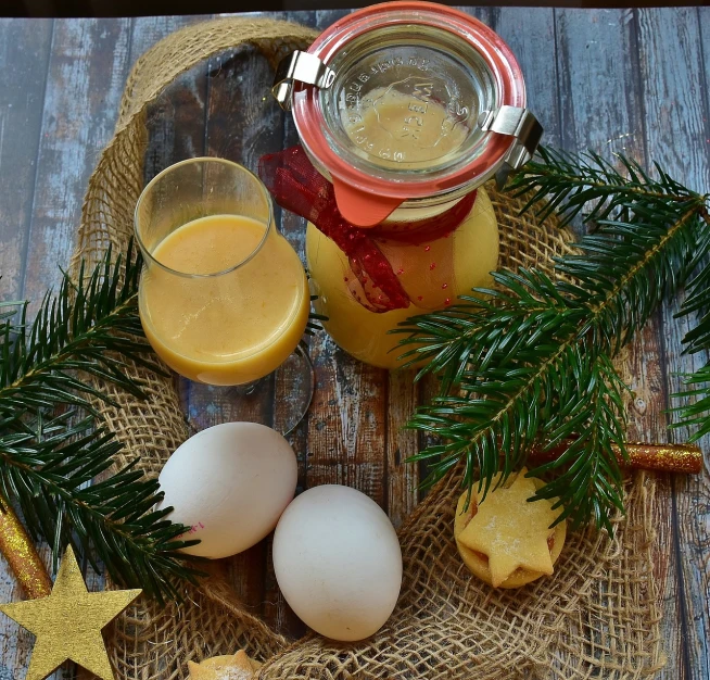 a table topped with eggs and a glass of orange juice, a photo, pixabay, christmas, inside a glass jar, yeast, tan