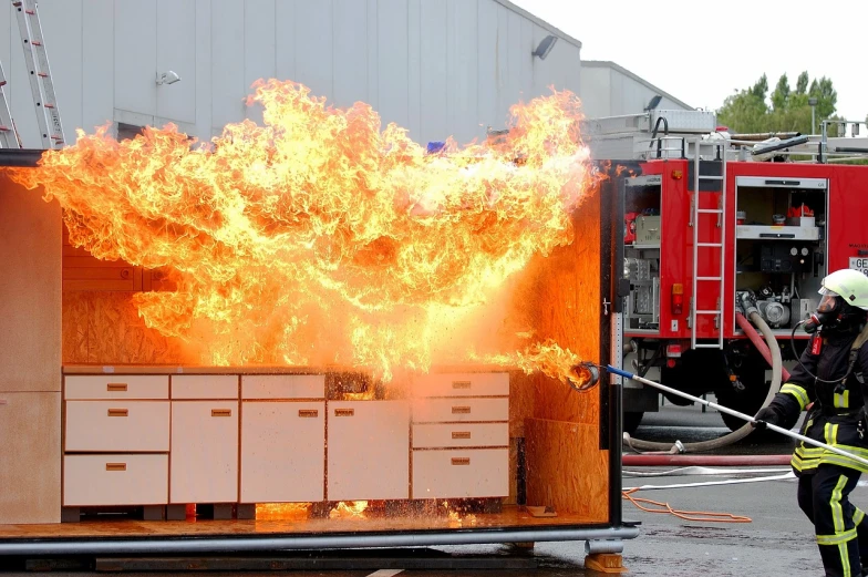 a firefighter using a hose to put out a fire, elaborate rube goldberg style, trailer, prototype, 4800k