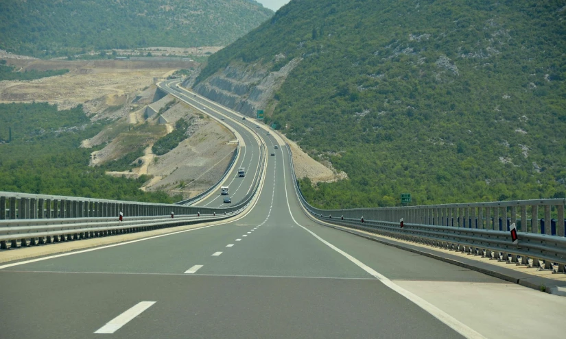 a couple of cars driving down a highway, a picture, inspired by Jan Kupecký, shutterstock, ponte 2 5 de abril, hilly road, turkey, maintenance photo