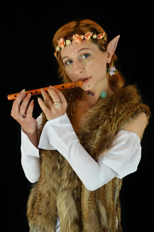 a woman dressed in costume playing a flute, a character portrait, inspired by Wendy Froud, flickr, girl with fox ears, teen elf girl, cosplay photo, very accurate photo