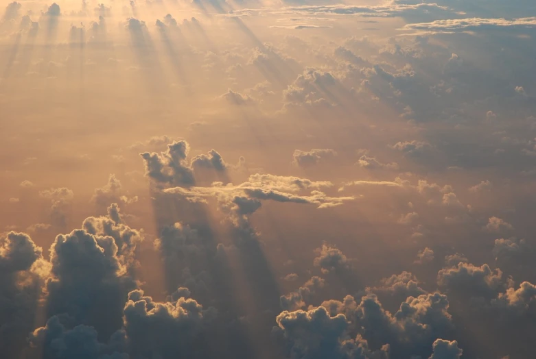 the sun shines brightly through the clouds, by Steven Belledin, light and space, from above, god light shafts, loots of clouds, seen from straight above