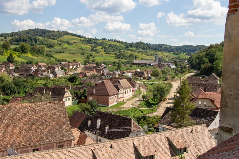 a view of a town from the top of a hill, shutterstock, romanian heritage, wide view of a farm, shot from roofline, shaded