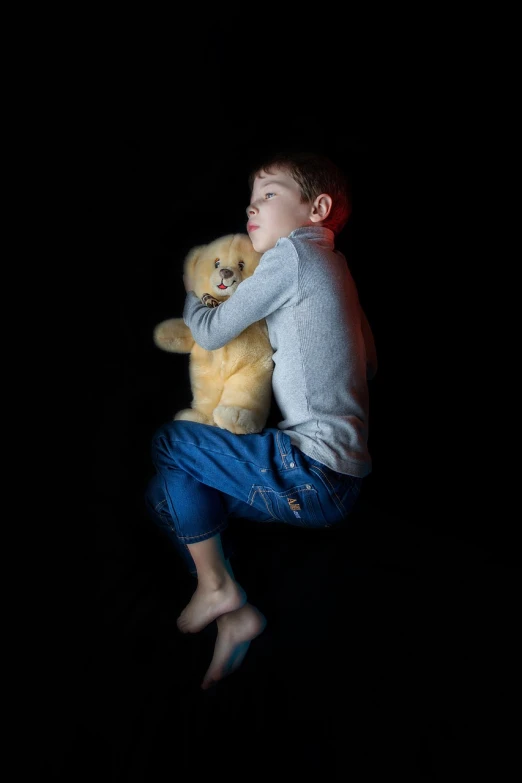 a young boy holding a teddy bear in the dark, a stock photo, long exposure photo, hyper real photo, with his hyperactive little dog, resting on a pillow