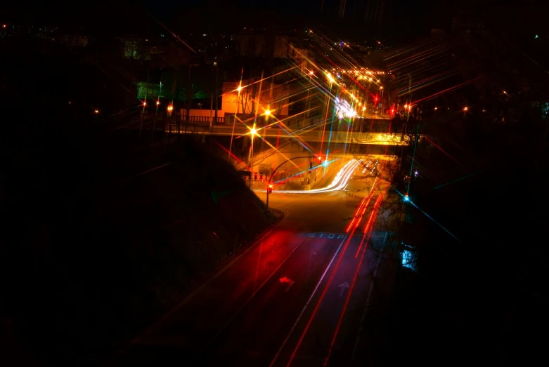 a city street filled with lots of traffic at night, a picture, by Thomas Häfner, flickr, happening, lightpainting luminescent, sloped street, vladimir krisetskiy, industrial photography