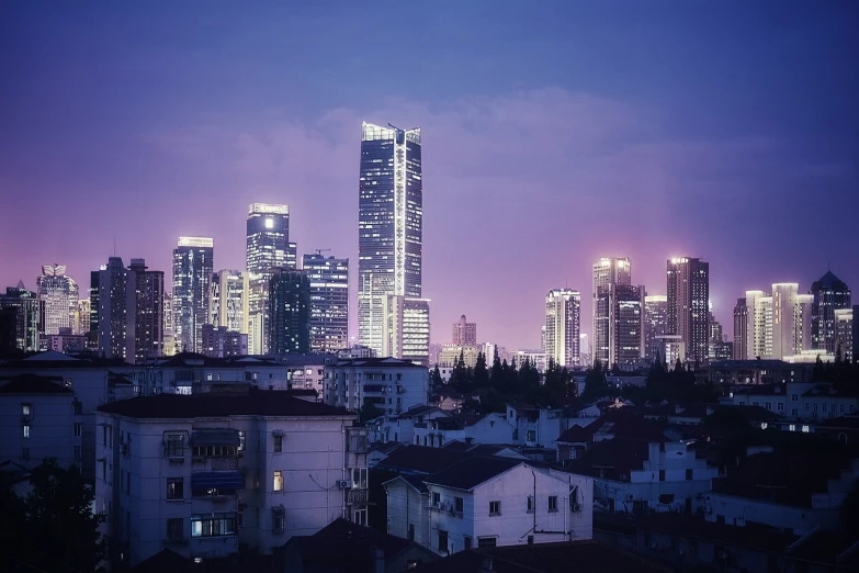 a view of a city at night from a rooftop, inspired by Cheng Jiasui, pexels contest winner, purple light, white pale concrete city, zezhou chen, high rise skyscrapers