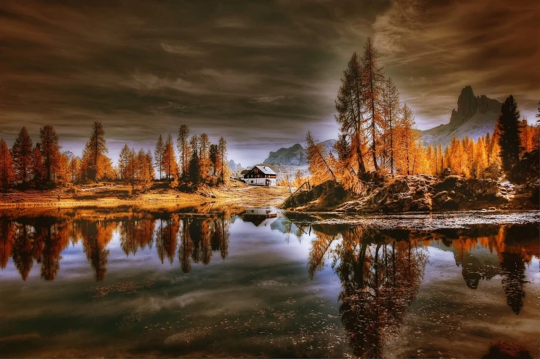 a large body of water surrounded by trees, a matte painting, by Erik Pevernagie, pixabay contest winner, romanticism, dolomites, dramatic autumn landscape, solitary cottage in the woods, hdr refractions