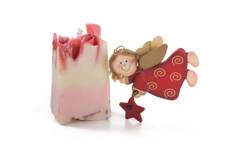 a soap bar with a little angel figurine next to it, by Marie Angel, strawberry embellishment, gooey, mikko, full of joy