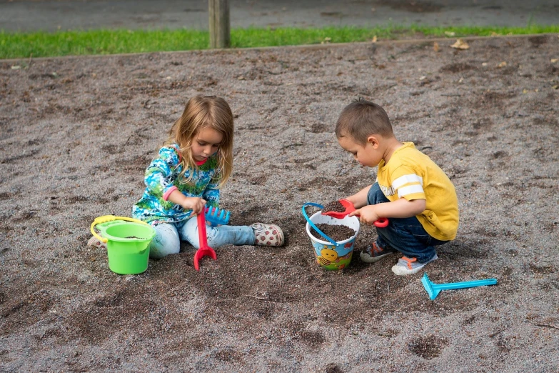 a boy and a girl playing in the sand, by Harold von Schmidt, pixabay, at a park, maintenance photo, toys, high res photo