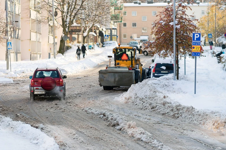 a red truck driving down a snow covered street, by Ejnar Nielsen, shutterstock, arbeitsrat für kunst, people at work, digging, person in foreground, helsinki