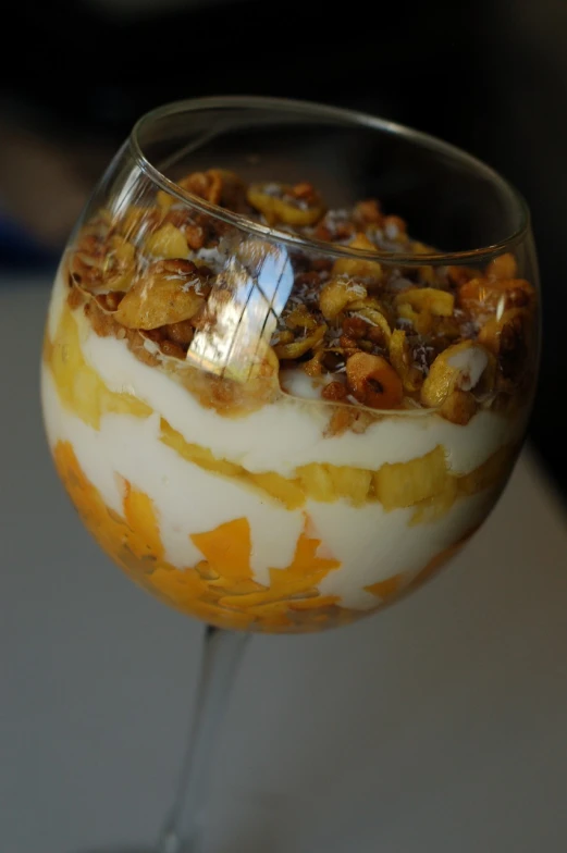 a close up of a dessert in a glass, by Ella Guru, flickr, cereal, pineapples, orange, sea of parfait