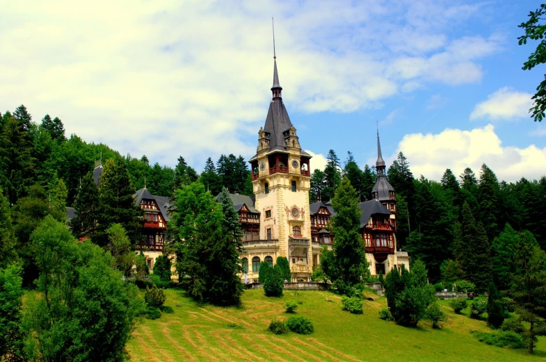 a castle sitting on top of a lush green hillside, a photo, art nouveau, romanian heritage, ornate wood, stunning grand architecture, vacation photo