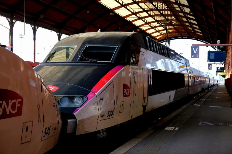 a large long train on a steel track, by Jens Søndergaard, flickr, traveling in france, train station, nice face, tgv