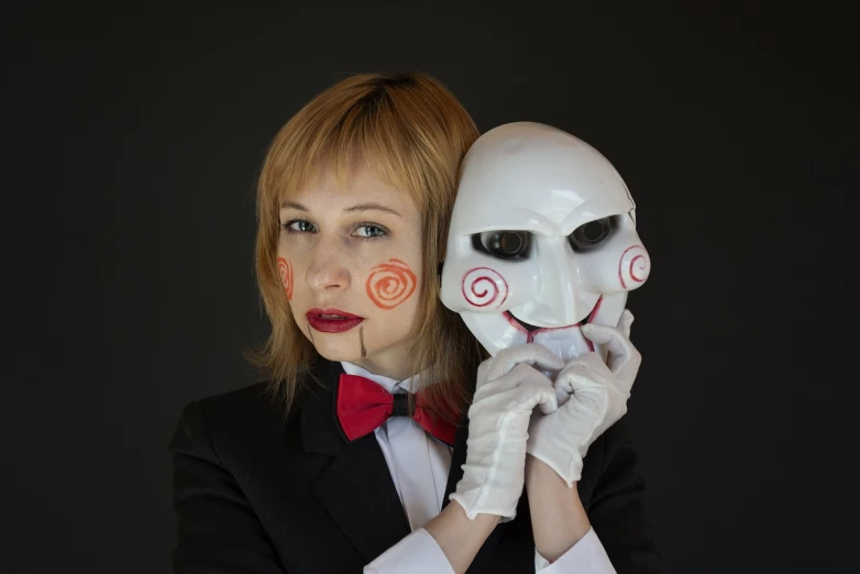 a woman in a tuxedo holding a white mask, inspired by Alfred Freddy Krupa, flickr, chainsaw man, clown girl, still from the movie saw, robot portrait