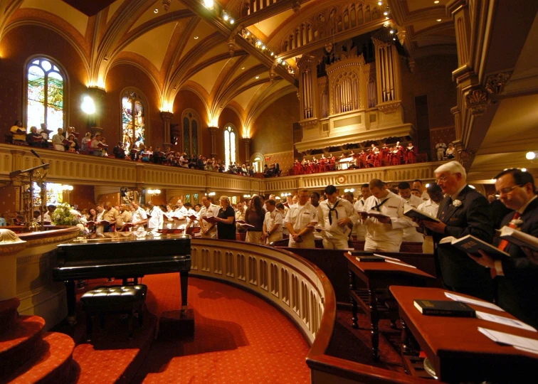 a group of people that are standing in front of a piano, by Robert Medley, pexels, precisionism, church interior, crimson and white color scheme, boston, below is the crowd