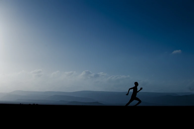 a silhouette of a person running on a hill, by Julian Allen, unsplash, minimalism, blue sky, marsden, benjamin vnuk, tai chi