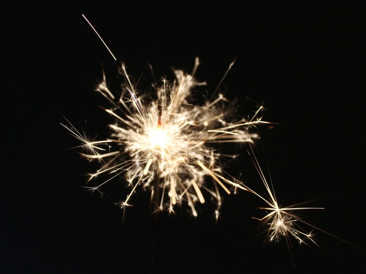 a close up of a sparkler in the dark, a picture, figuration libre, high res photo