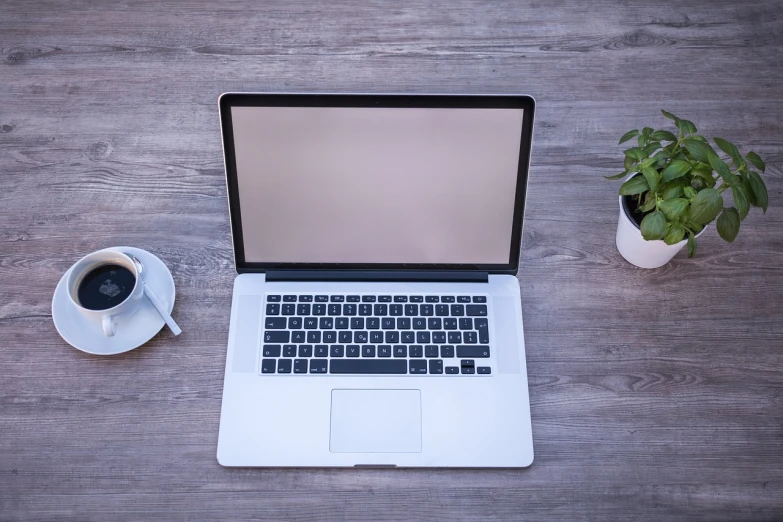 a laptop computer sitting on top of a wooden table next to a cup of coffee, by Kurt Roesch, pixabay, istockphoto, completely empty, high res photo, photostock