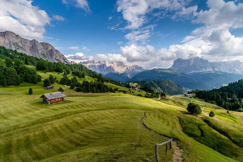 a house sitting on top of a lush green hillside, a stock photo, shutterstock, dolomites, wide view of a farm, high quality image”