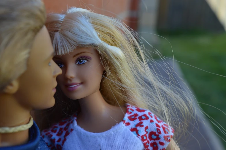 a couple of dolls standing next to each other, a picture, pixabay, happening, has long blonde hair, kiss mouth to mouth, barbie or ken doll, summer morning