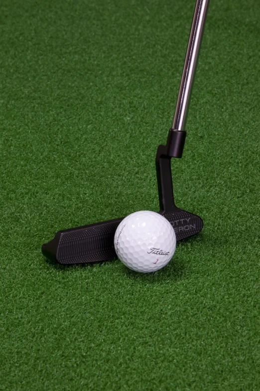 a golf ball sitting next to a golf club, inspired by Shirley Teed, photorealism, all black matte product, fake grass, product introduction photo, foam