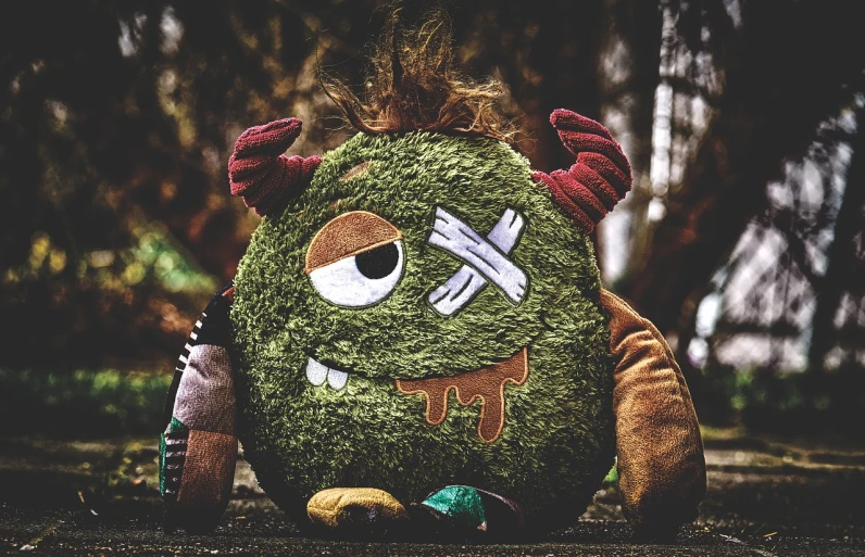 a close up of a stuffed animal on the ground, a picture, lowbrow, cute monster, avatar image, gritty image, profile picture 1024px