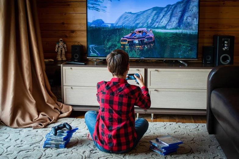 a person sitting on the floor playing a video game, a picture, by Adam Marczyński, shutterstock, hyperrealism, wearing a red lumberjack shirt, sports car in the room, in foreground boy with shotgun, stock photo