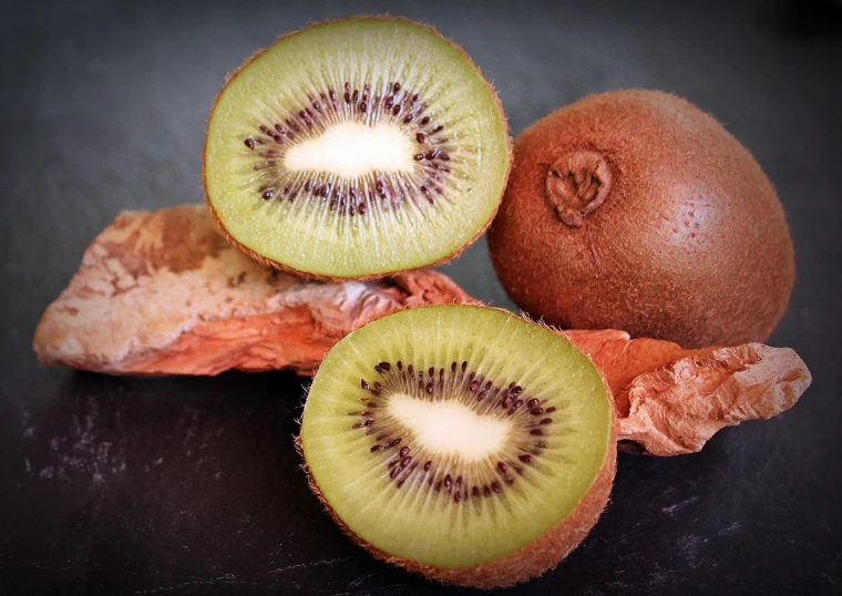 a close up of a kiwi fruit cut in half, a portrait, flickr, north island brown kiwi, grape, stuffed, full subject shown in photo