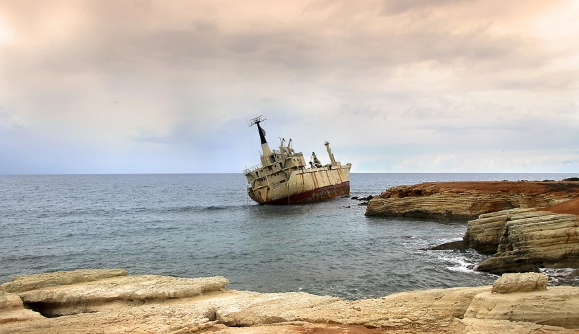 a boat sitting on top of a body of water, by Edwin Georgi, pixabay, surrealism, destroyed ship, cyprus, portrait n - 9, agrigento