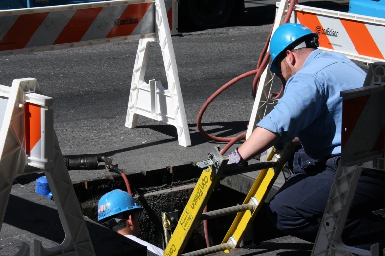 a man that is standing next to a fire hydrant, by Ken Elias, shutterstock, happening, crawling in a wet sewer pipe, heavy line work, sitting down, wires hanging above street