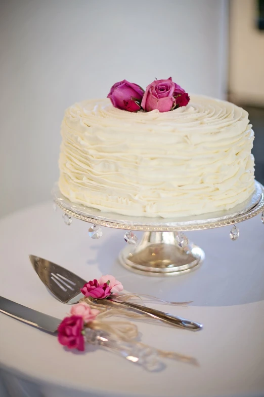 a white cake sitting on top of a white table, a portrait, by Leonard Bahr, renaissance, rose, professionally taken, frill, simple yet detailed