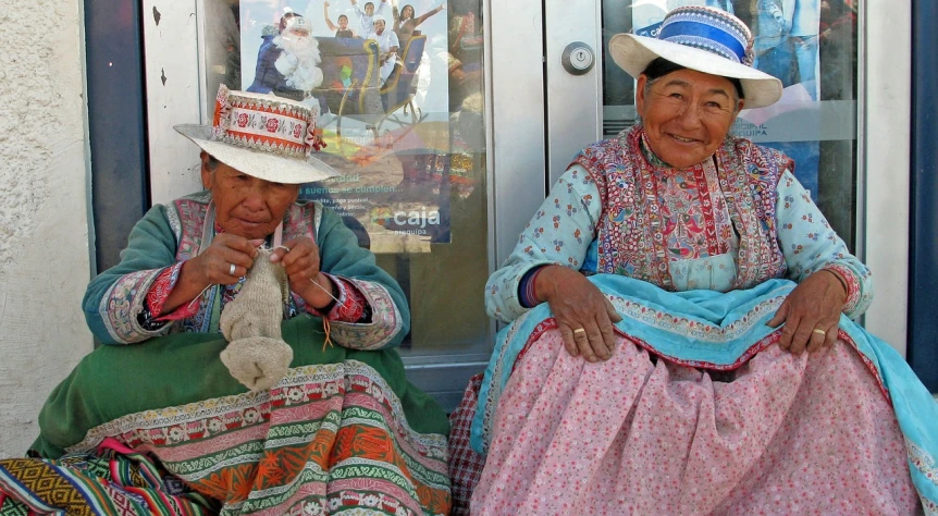 a couple of women sitting next to each other, a photo, flickr, cloisonnism, quechua!!, smiles and colors, waiting to strike, in clothes! intricate