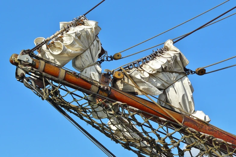 a close up of a sail on a body of water, inspired by Horatio Nelson Poole, shutterstock, baroque, huge pauldrons, silk tarps hanging, detail structure, viewed from the ground