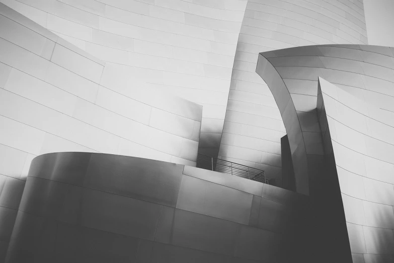 a black and white photo of a building, unsplash contest winner, light and space, los angeles 2 0 1 5, desaturated color, winding horn, shiny and metallic
