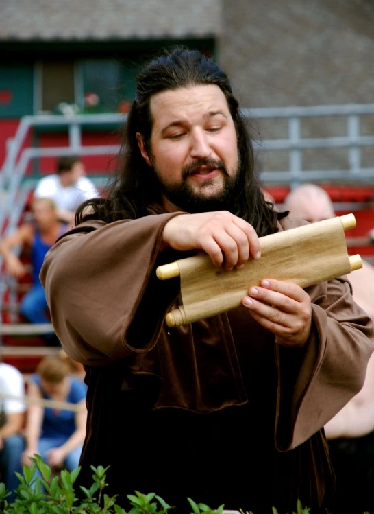 a man with long hair holding a baseball bat, inspired by János Saxon-Szász, flickr, renaissance, ricky berwick, taoist priest, renaissance fair, holding a wood piece