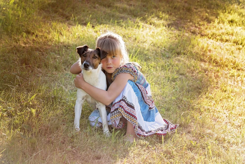 a little girl sitting in the grass with a dog, a photo, inspired by Elke Vogelsang, pixabay, renaissance, hug, jack russel terrier, evening sun, multi - layer