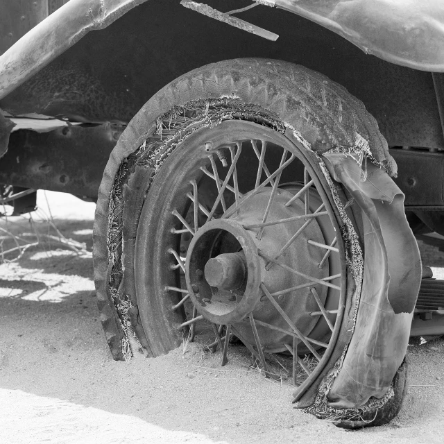 a black and white photo of a snow covered tire, by Dorothea Lange, fine art, cars crashed, cracked mud, ford model t, on the desert