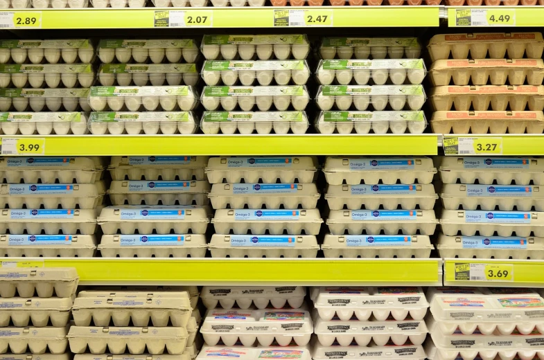 a bunch of eggs on a shelf in a store, a stock photo, by Robert Medley, shutterstock, ((in a super market costco)), scotland, summer 2016, stock photo
