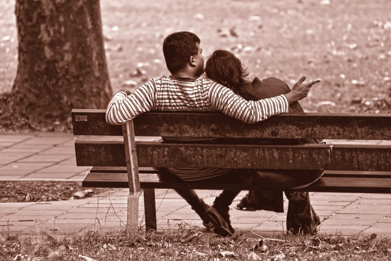 a man and a woman sitting on a bench, a photo, flickr, romanticism, embraced, long distance photo, enhanced photo, tourist photo