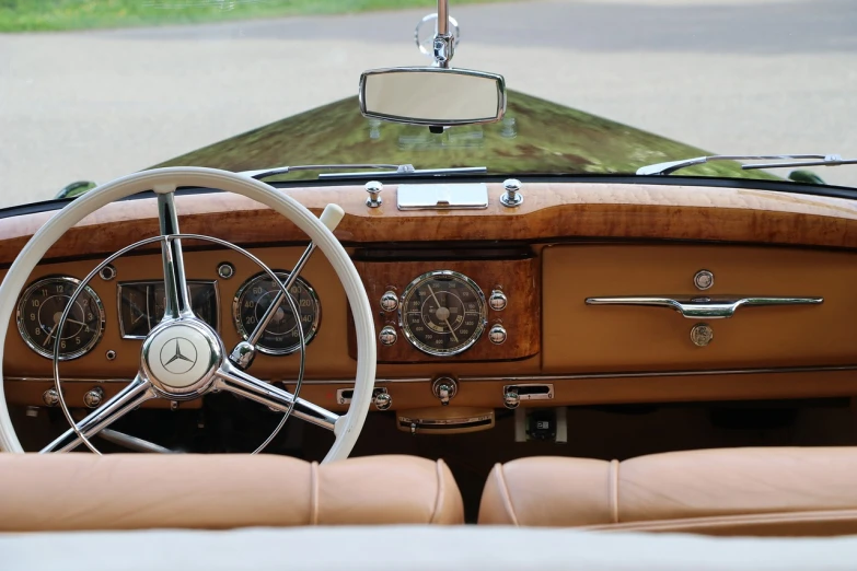 a close up of a steering wheel and dashboard of a car, by David Simpson, purism, looking regal and classic, varnished, convertable, mercedes