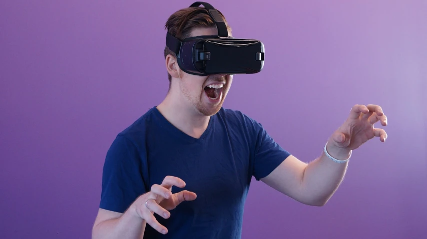 a man in a blue shirt wearing a virtual reality headset, by Jason Felix, hypermodernism, purple ambient light, doing a sassy pose, linus tech tips, official product photo