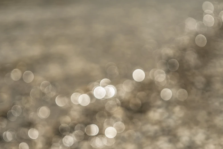 a red fire hydrant sitting on top of a sandy beach, a microscopic photo, minimalism, refracted sparkles, overcast bokeh - c 5, soft sepia tones, water reflecting suns light