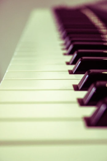 a close up of the keys of a piano, a picture, by Karl Buesgen, unsplash, synthetism, purple - tinted, banner, shot on kodak vision 200t, colored accurately
