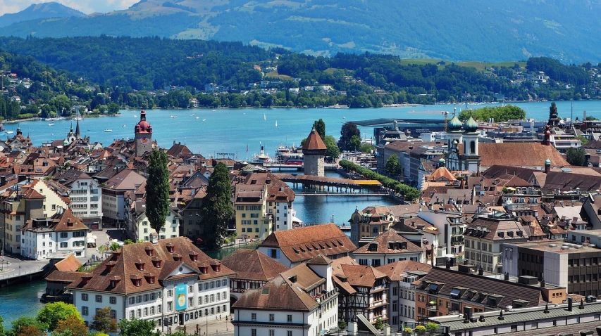 a view of a city with mountains in the background, by Karl Stauffer-Bern, shutterstock, harbor, top down view, well edited, photo taken in 2018