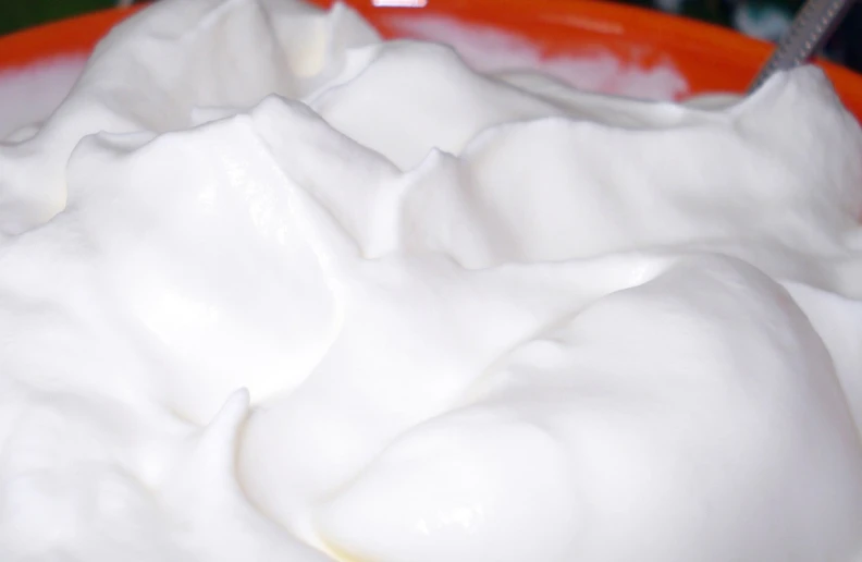 a bowl of whipped cream with a spoon in it, by Helen Dahm, flickr, organic detail, jello, close up angle, plenty mozzarella