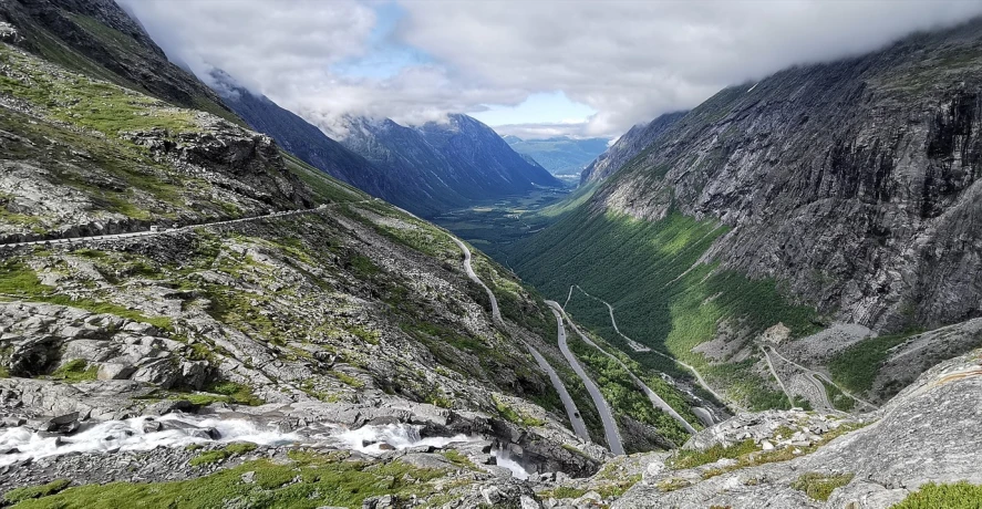 a group of people standing on top of a mountain, a photo, unobstructed road, norwegian landscape, lush valley, roads