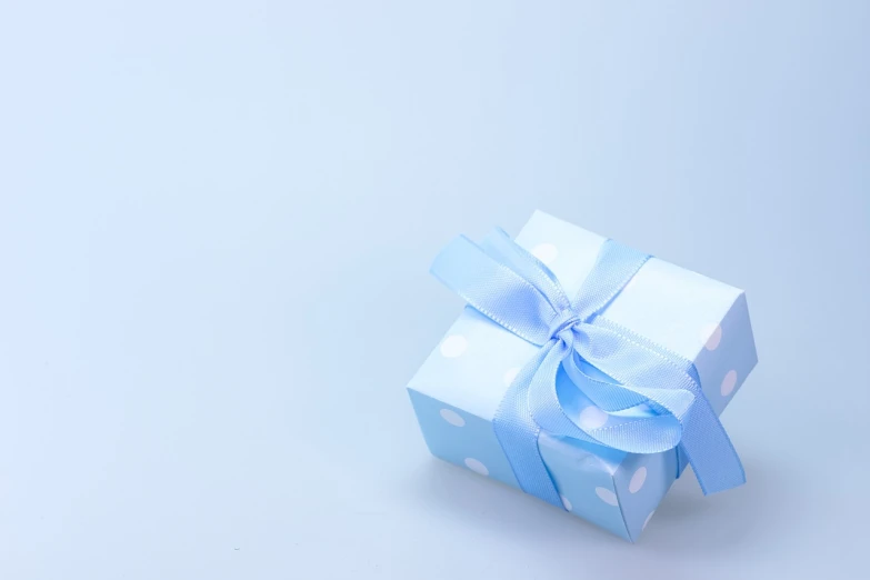 a small blue gift box with a blue bow, pixabay, visual art, light blue background, 中 元 节, product introduction photo, polka dot