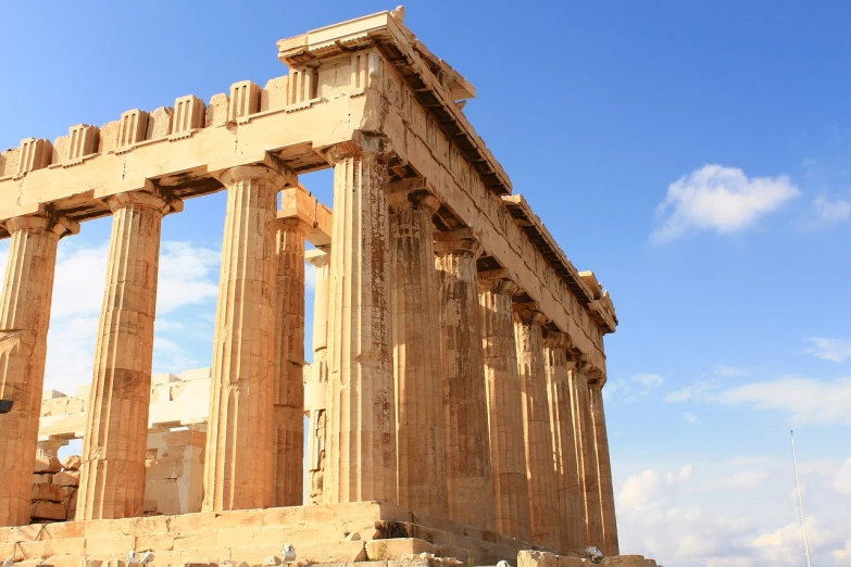 a group of people that are standing in front of a building, by Paul Emmert, shutterstock, neoclassicism, parthenon, cinematic view from lower angle, beautiful sunny day, huge old ruins