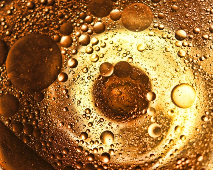 a close up of water droplets on a glass, a macro photograph, renaissance, cooking oil, gold gilded circle halo, soda, detailed product photo