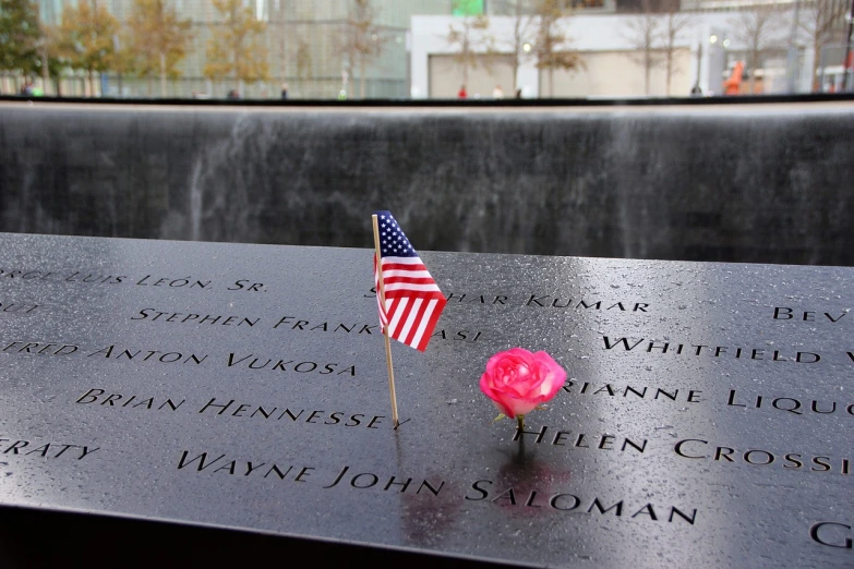 a rose and an american flag placed on a memorial, by Bernie D’Andrea, flickr, modernism, fountain, twin towers, slate, tourist destination